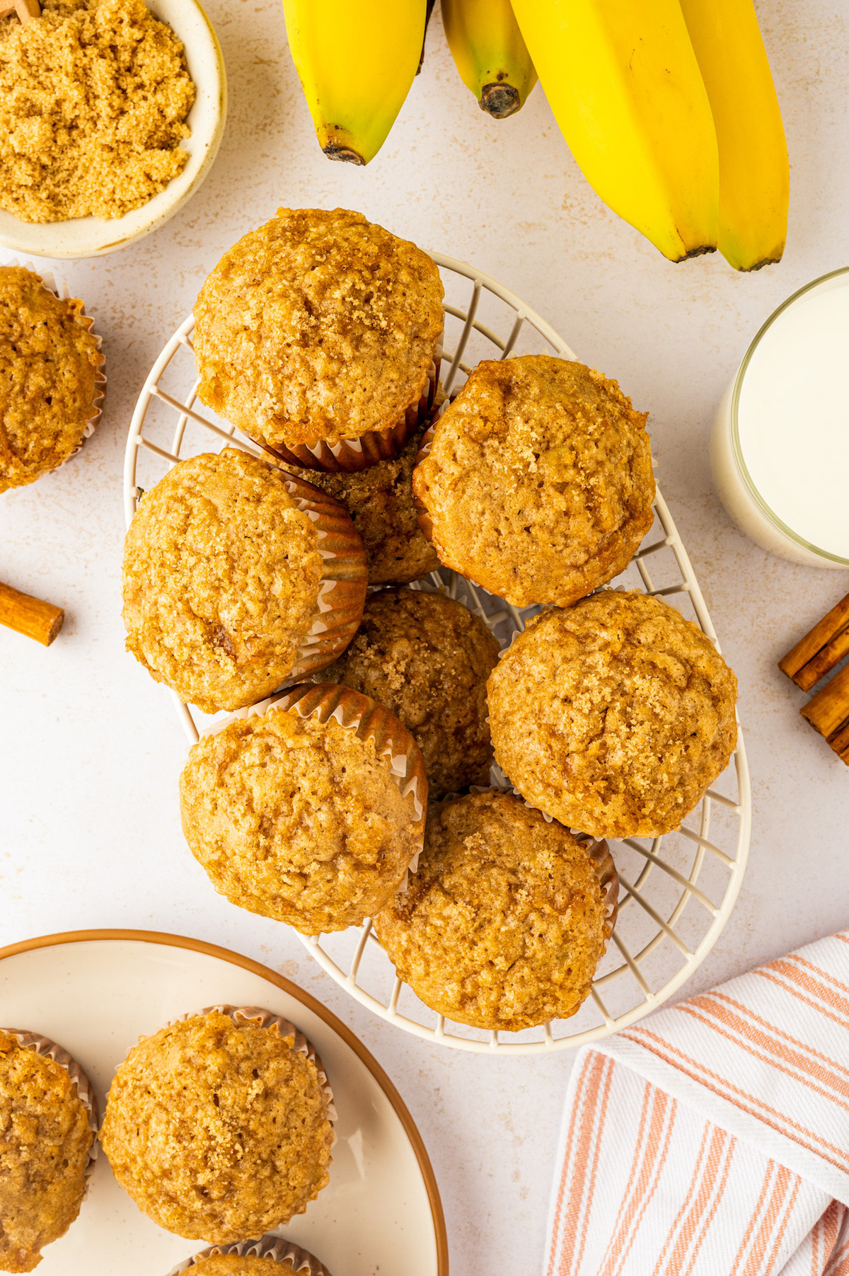 Small wire basket filled with moist banana muffins with a brown sugar topping.