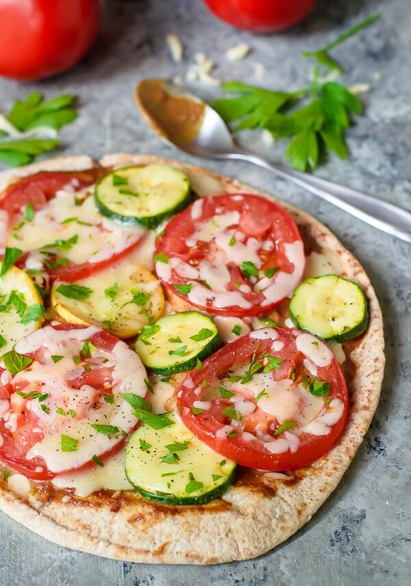 An Easy Veggie Pita Pizza on a Marble Counter