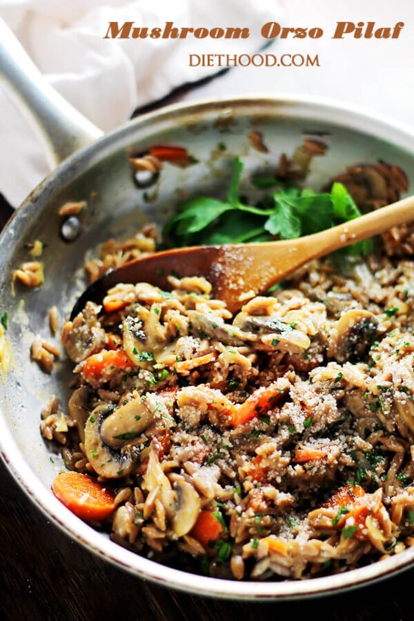 Mushroom Orzo Pilaf in a Metal Skillet with a Wooden Spoon