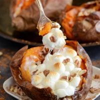 Baked sweet potatoes stuffed with marshmallows, pecans, butter and cinnamon.