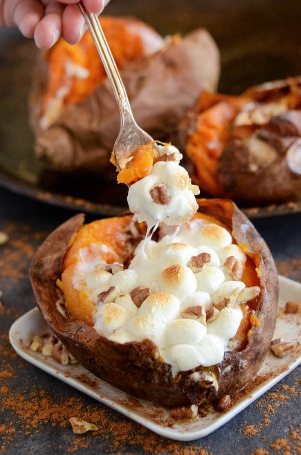 Baked sweet potatoes stuffed with marshmallows, pecans, butter and cinnamon.
