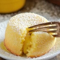 A Close-Up Shot of a Lemon Cake Bursting with White Chocolate Lemon Curd Filling on a Plate
