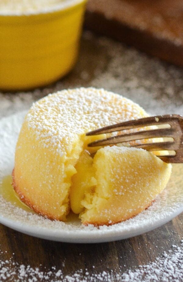 A Close-Up Shot of a Lemon Cake Bursting with White Chocolate Lemon Curd Filling on a Plate