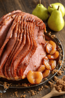Pear Glazed Ham on a serving platter with fresh pears