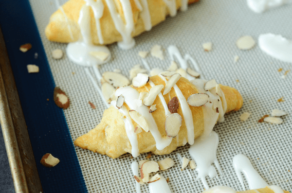 An Almond Stuffed Crescent Roll Topped with Icing and Chopped Almonds