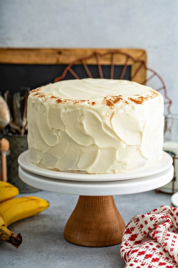 Frosted banana cake on a table.