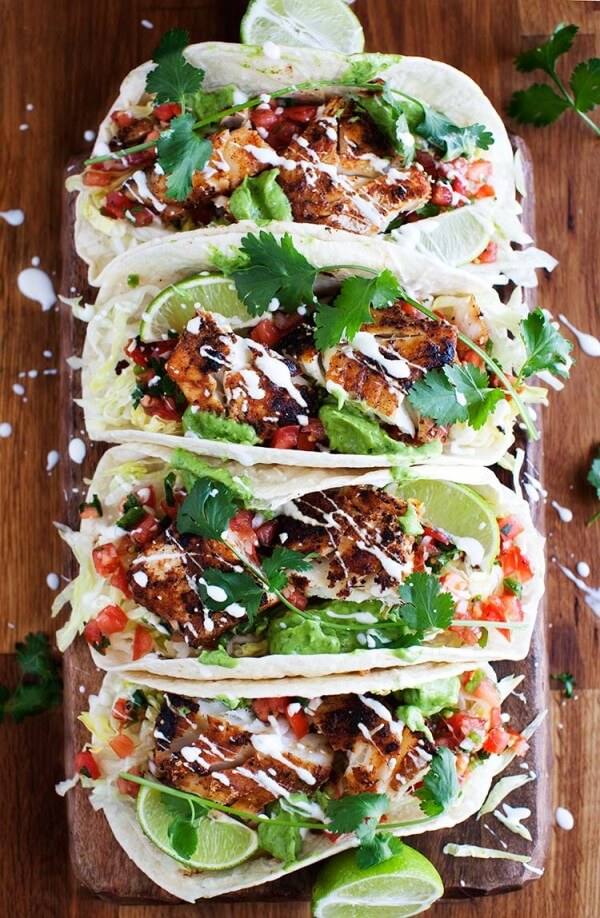 Four Cajun Fish Tacos on a Wooden Table