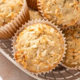 Coconut banana muffins in a wire basket.