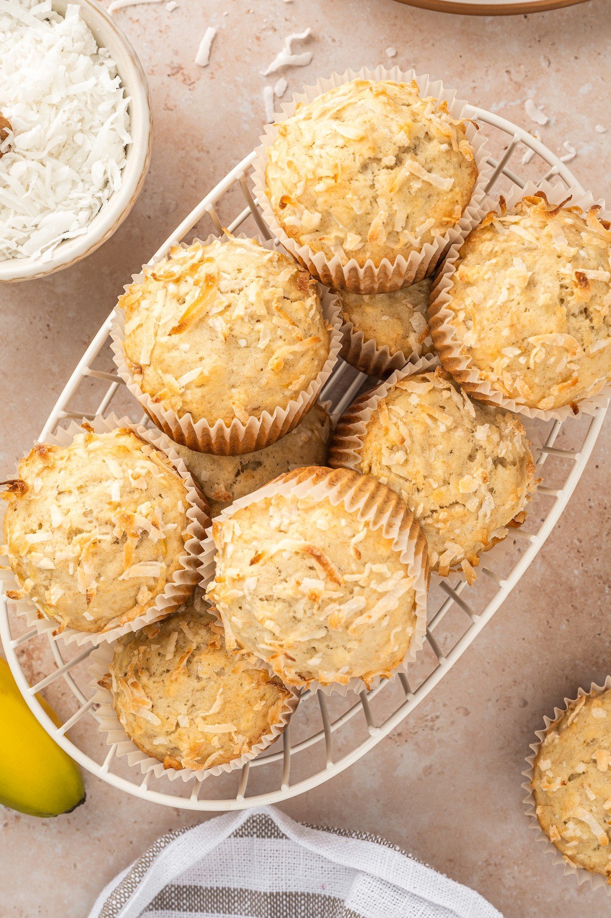 Coconut banana muffins in a wire basket. 