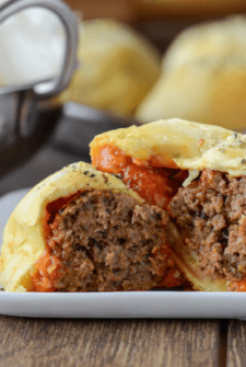 Meatball Bombs with marinara sauce and garlic butter on a plate.