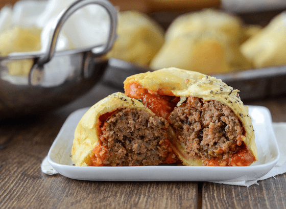 Meatball Bombs with marinara sauce and garlic butter on a plate.