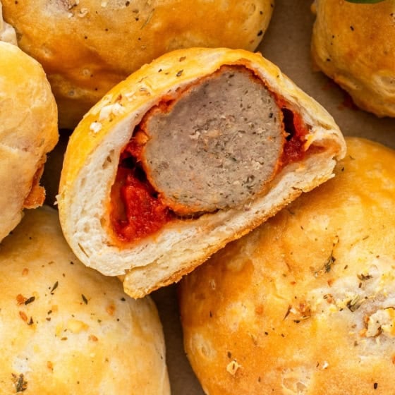 A single meatball appetizer has been cut in half, showing a fully cooked center.