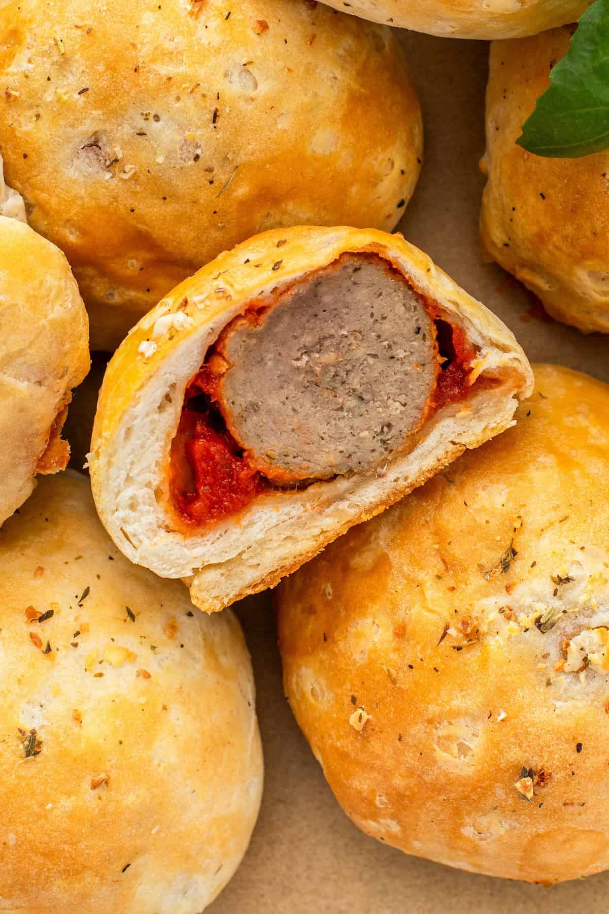 A single meatball appetizer has been cut in half, showing a fully cooked center.