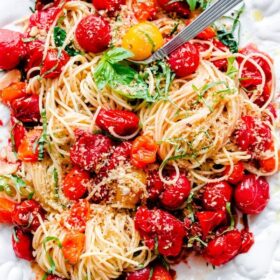 Spaghettini With Roasted Tomatoes, Basil And Crispy Breadcrumbs on a White Platter
