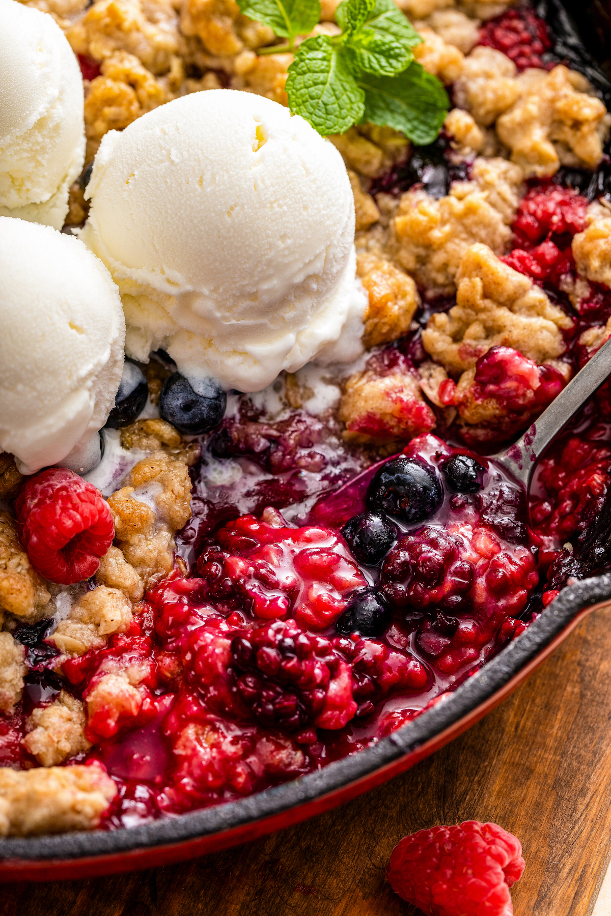 Digging into the berry cobbler with a spoon.