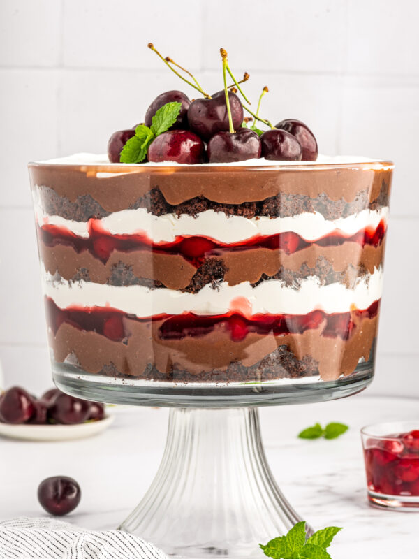 A layered trifle made with chocolate and cherries.
