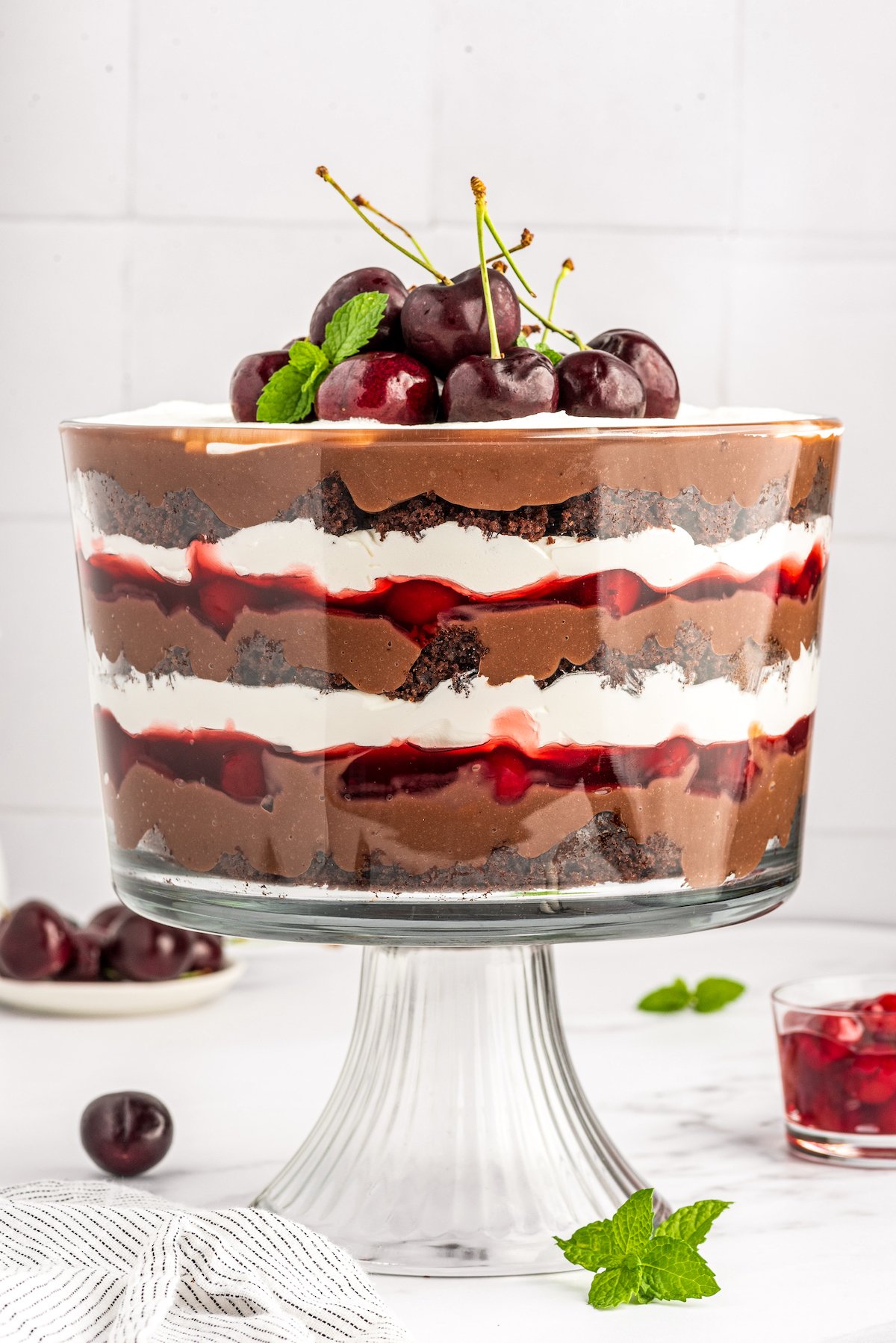 A layered trifle made with chocolate and cherries.