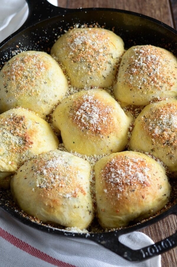 A cast iron skillet filled with freshly baked broccoli & cheese bombs.