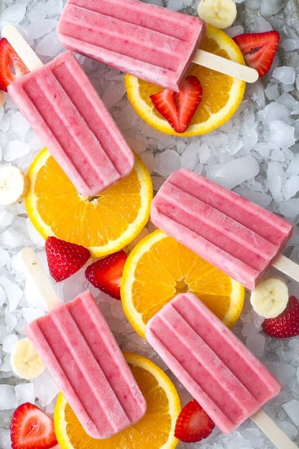 Fruit Smoothie Popsicles with Strawberries, Banana Slices and Sliced Oranges