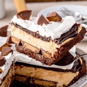 A slice of peanut butter pie from the side, showing the layers.