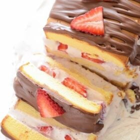 Strawberry Ice Cream Cake! An easy recipe using store bought pound cake, strawberry ice cream, fresh strawberries and chocolate to create a no-bake frozen Strawberry Ice Cream Cake!