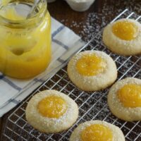 A Batch of Round Shortbread Cookies Filled with Lemon Curd and Garnished with Powdered Sugar