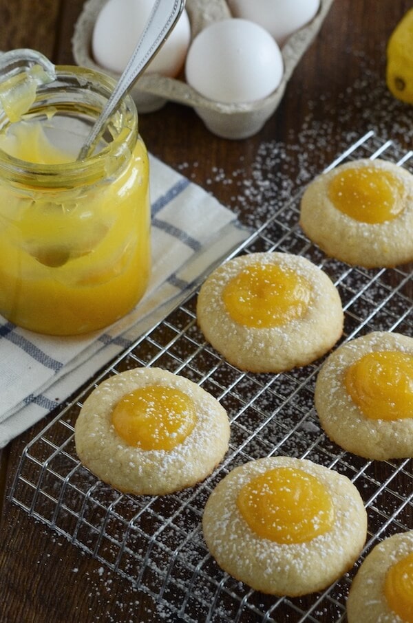 A Batch of Round Shortbread Cookies Filled with Lemon Curd and Garnished with Powdered Sugar