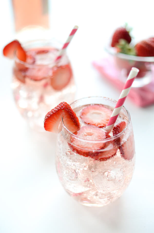 A Glass of Pink Strawberry Sangria with a Straw