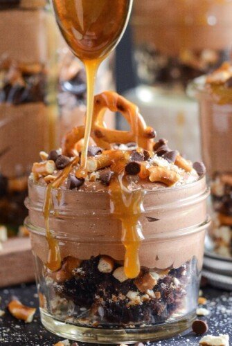 This chocolate trifle recipe is filled with gooey caramel, crunchy pretzels, and whipped chocolate and peanut butter cream cheese filling.