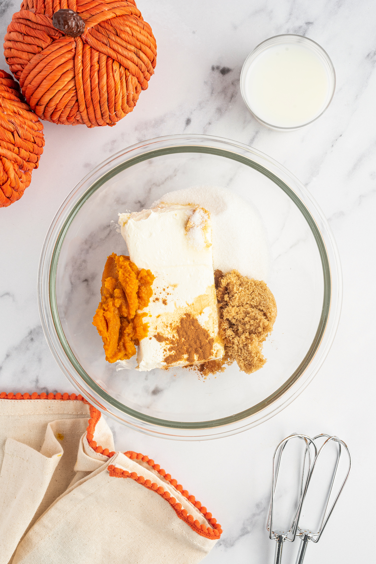 Ingredients for the cinnamon pumpkin cream cheese dip in a bowl.