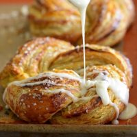 Pumpkin Twists: Flaky puff pastry is stuffed with spiced pumpkin and topped with a vanilla glaze!