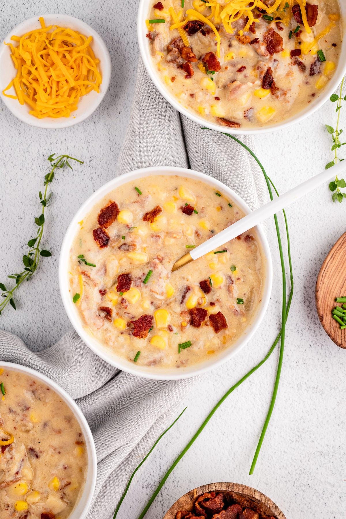 Three bowls of bacon corn chowder.