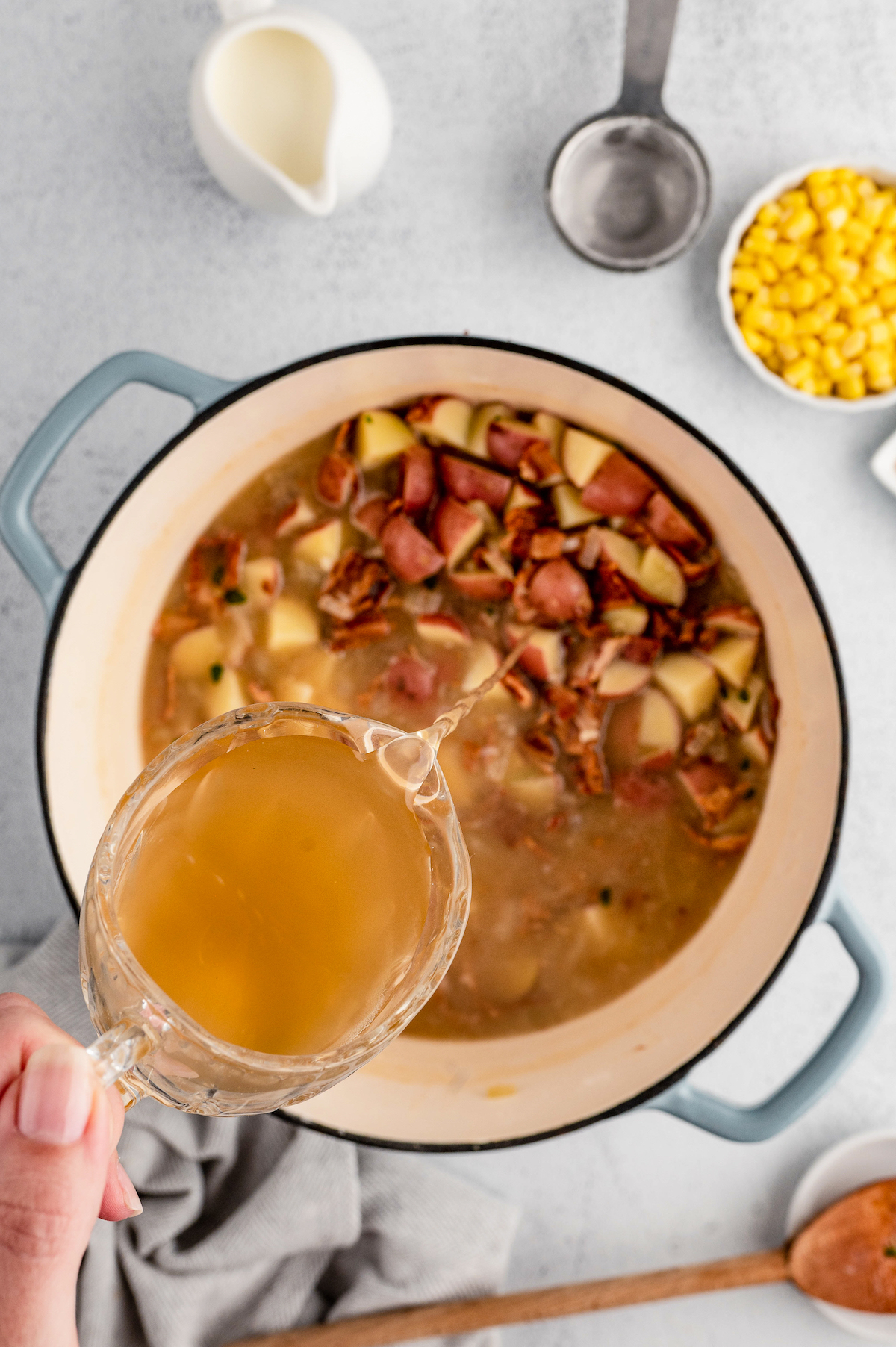 Pouring the chicken stock in.