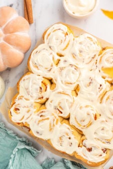Baking pan with frosted cinnamon rolls inside.