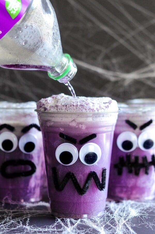 Purple People Eater Floats! Create this fun Halloween treat with the kids with pipe cleaners, hot glue, plastic cups, vanilla ice cream and purple grape soda! 