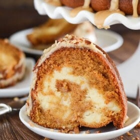 Sweet Potato Cream Cheese Bundt Cake with Praline Frosting! Looking for an impressive cake you can serve for dessert or breakfast? This rich, moist, sweet potato spiced cake is swirled with sweet cream cheese and topped with a pecan praline frosting.