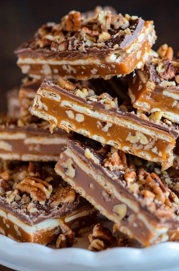 Pecan Caramel Bars stacked on top of each other on a plate. 