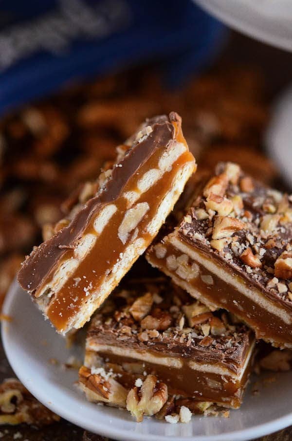 Up close image of three Pecan Caramel Bars stacked on top of each other.