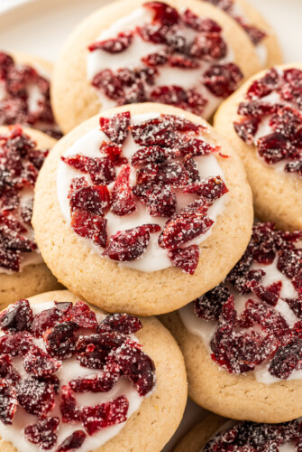 Cranberry cookies with frosting and sugared, dried cranberries on top.