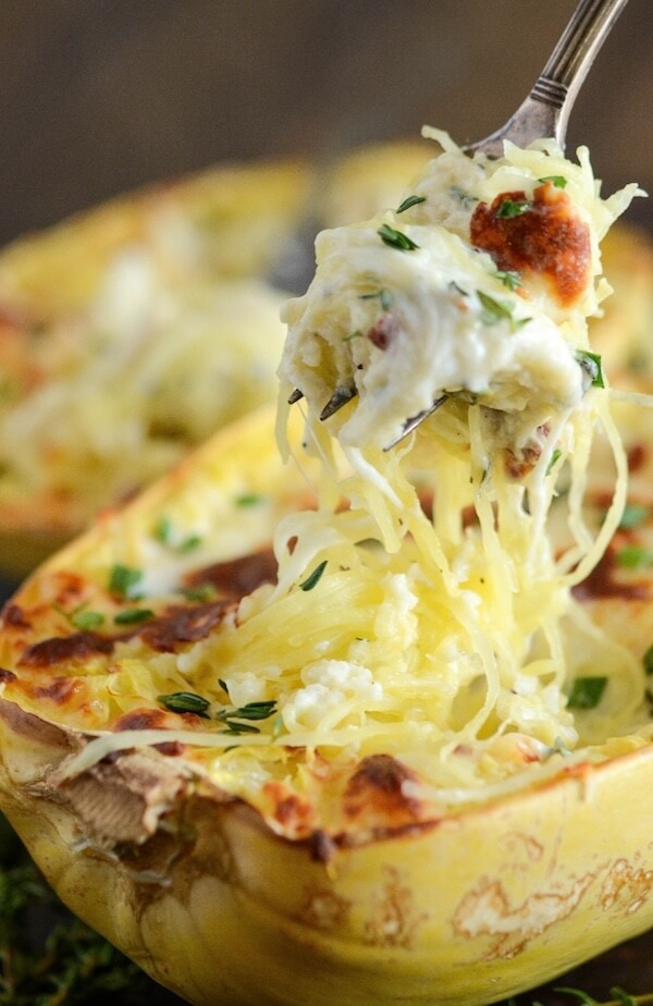 A Fork Lifing a Bite From a Roasted Spaghetti Squash with Cheese and Chicken