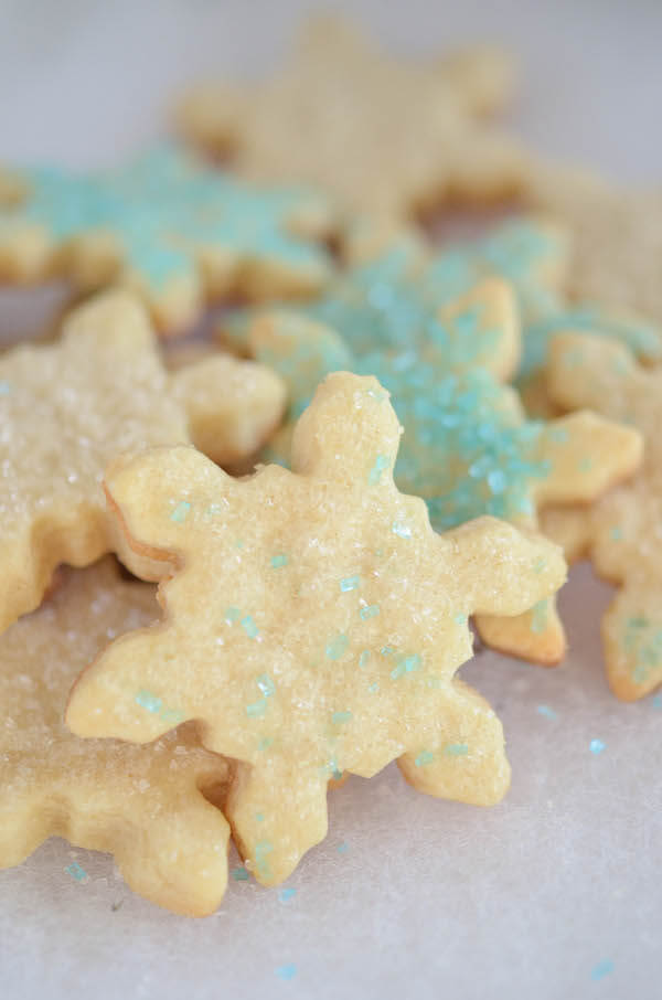 A pile of decorated Snowflake Cut Out Sugar Cookies