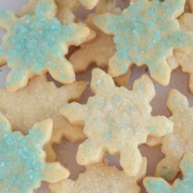 An assortment of blue and white-decorated Snowflake Cut Out Sugar Cookies