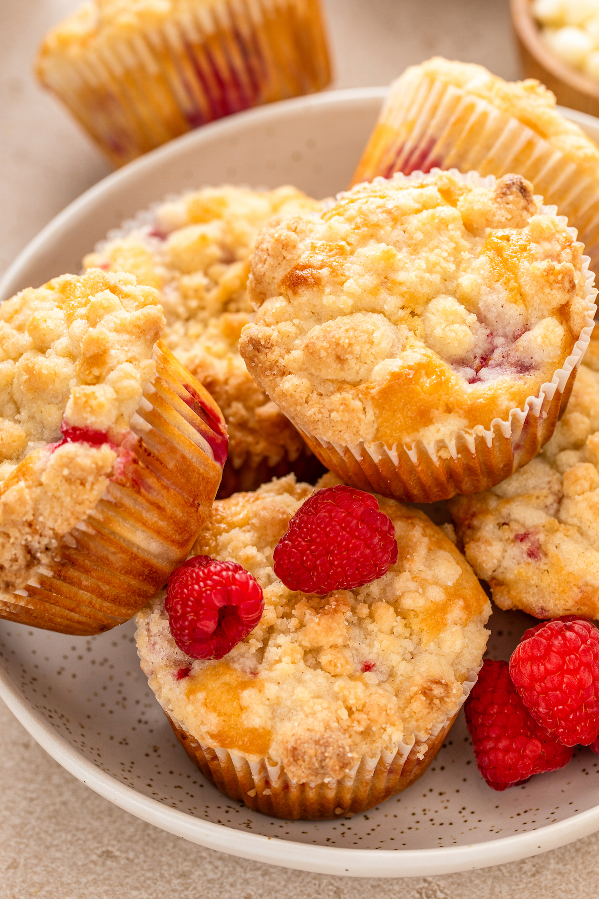 Sweet raspberry muffins with white chocolate chips in a bowl. 