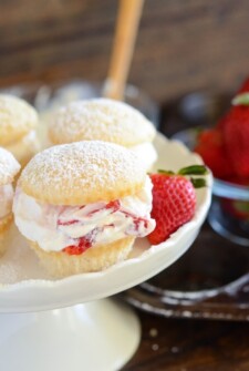 Strawberries and Cream Cupcakes: Light fluffy white cupcakes are filled with juicy fresh strawberries and sweet whipped cream to create a light and bright dessert!