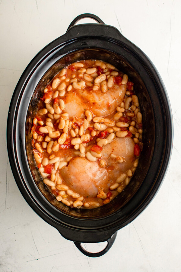 Chicken, beans, rotel and seasonings in a crockpot.