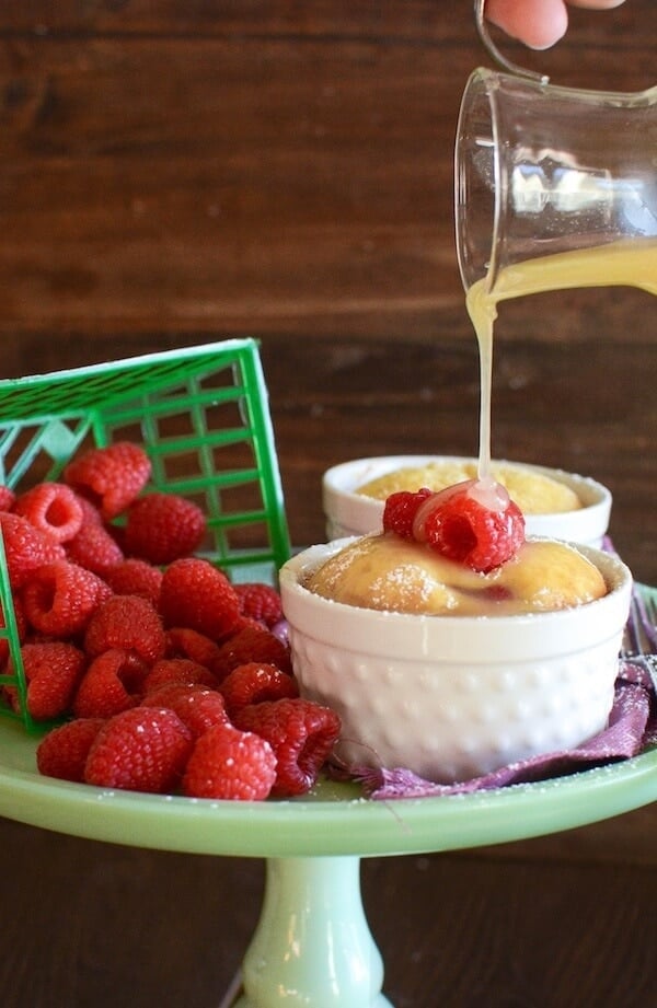 Warm Raspberry Pudding Cake with a vanilla butter sauce! It's a delicious easy way to impress your guests and no one would ever guess it started with a boxed cake mix!