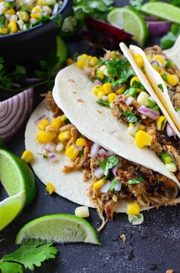 Crispy Pork Carnitas with Corn Salsa - easy pork carnitas are made in a slow cooker or instant pot and then pan fried till crispy. Serve them as tacos with fresh corn salsa, with rice and beans or with eggs for breakfast! 