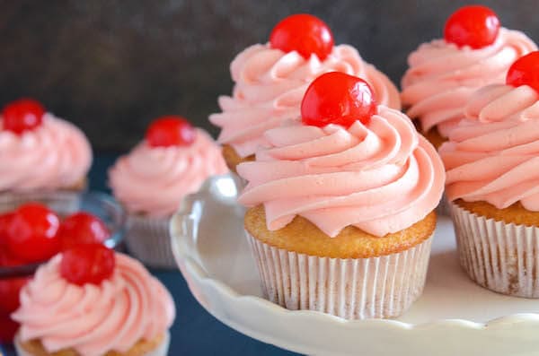 Maraschino Cherry Cupcakes: Sweet almond scented cupcakes are filled with bites of red maraschino cherries and topped with a gorgeous bright maraschino cherry buttercream!