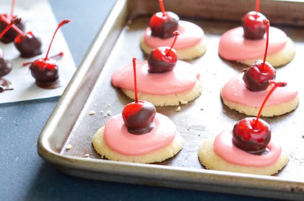 Cherry Cordial Cookies: these intricate looking cookies are surprisingly easy to make. You start with a soft shortbread cookie base, spread them with a creamy cherry cordial icing and top them with a chocolate cherry. 