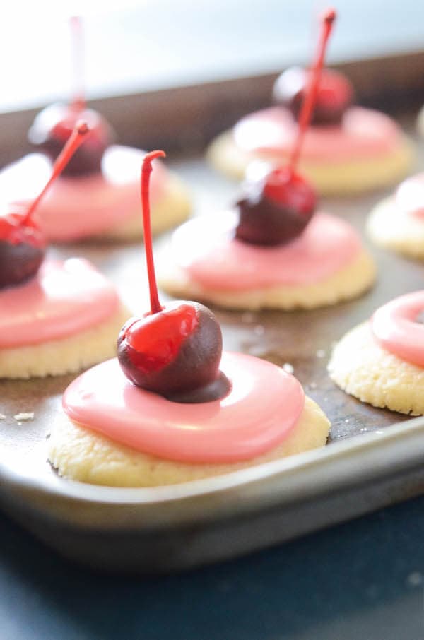 Cherry Cordial Cookies: these intricate looking cookies are surprisingly easy to make. You start with a soft shortbread cookie base, spread them with a creamy cherry cordial icing and top them with a chocolate cherry. 